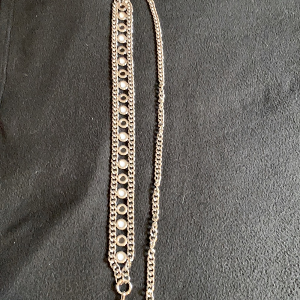 Silver chain belt with black and opal details and a pearl drop.